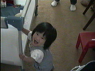 Angela tries to break into her playpen.